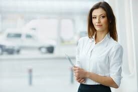 woman with book looking at camera