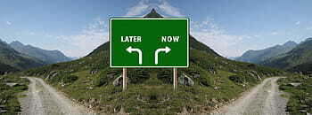 crossroads with one arrow pointing to 'later' and one pointing to 'now'